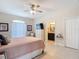 Serene main bedroom with neutral tones, a ceiling fan, and an en-suite bathroom at 12323 House Finch, Weeki Wachee, FL 34614