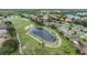 Beautiful aerial view of a pond on a lush golf course surrounded by lovely homes at 1242 Almondwood Dr, Trinity, FL 34655