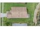 Aerial view of the home's roof and surrounding landscaping, complete with a screened-in lanai at 1242 Almondwood Dr, Trinity, FL 34655