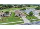 Beautiful aerial view of home overlooking a pond and golf course in a serene community at 1242 Almondwood Dr, Trinity, FL 34655