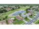 Gorgeous aerial view of a lush golf course, tranquil pond, and beautiful homes at 1242 Almondwood Dr, Trinity, FL 34655