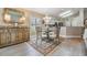 Elegant dining room with a glass table, decorative rug, and custom buffet cabinet, perfect for entertaining at 1242 Almondwood Dr, Trinity, FL 34655