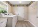 Bright laundry room with a window, washer, dryer, and useful storage at 1242 Almondwood Dr, Trinity, FL 34655