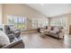 Bright living room with high ceilings, plantation shutters, and comfortable seating at 1242 Almondwood Dr, Trinity, FL 34655