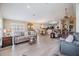 Spacious living area with a view into the dining and kitchen, featuring wood floors at 1242 Almondwood Dr, Trinity, FL 34655