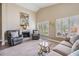 Inviting living room with a fireplace, comfortable seating, and natural light from the shuttered windows at 1242 Almondwood Dr, Trinity, FL 34655