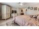 Spacious main bedroom featuring wood floors, a king bed and dresser at 1242 Almondwood Dr, Trinity, FL 34655