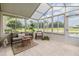 Relaxing sunroom with tile floor, bright light, comfortable seating, and a view of the outdoors at 1242 Almondwood Dr, Trinity, FL 34655