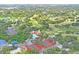 Amazing aerial view of the community clubhouse, tennis courts, pool, and lush green golf course at 13009 Wedgewood Way # 63-D, Hudson, FL 34667