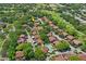 Overhead of the community highlighting the pool, shuffleboard courts, and landscaped grounds at 13009 Wedgewood Way # 63-D, Hudson, FL 34667