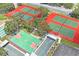 Community with tennis, basketball, and bocce ball courts surrounded by lush trees at 13009 Wedgewood Way # 63-D, Hudson, FL 34667