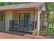 Upper-level balcony features neutral siding, black railings, sliding glass doors, and a cozy outdoor seating area at 13009 Wedgewood Way # 63-D, Hudson, FL 34667