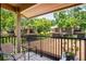 Spacious balcony overlooking a lush yard, with trees, a table and chair setting the stage for relaxation at 13009 Wedgewood Way # 63-D, Hudson, FL 34667