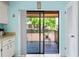 View from the kitchen to the outdoor balcony featuring a sliding glass door, an outdoor porch, and an adjacent storage closet at 13009 Wedgewood Way # 63-D, Hudson, FL 34667