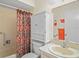 Cozy bathroom featuring a shower with curtain, vanity with storage, and a cabinet above the toilet at 13009 Wedgewood Way # 63-D, Hudson, FL 34667