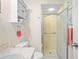 Bright bathroom with a walk-in shower, a storage cabinet, and neutral finishes creating a calming and functional space at 13009 Wedgewood Way # 63-D, Hudson, FL 34667