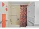 Functional bathroom featuring a bathtub with a shower curtain and a vanity with extra storage space at 13009 Wedgewood Way # 63-D, Hudson, FL 34667