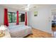 Comfortable bedroom featuring wood floors and a sunny window view at 13009 Wedgewood Way # 63-D, Hudson, FL 34667