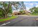 Beautiful clubhouse with a circular drive, covered entrance, and mature landscaping at 13009 Wedgewood Way # 63-D, Hudson, FL 34667