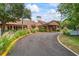 Inviting clubhouse with covered entrance, well-maintained grounds and vibrant landscaping at 13009 Wedgewood Way # 63-D, Hudson, FL 34667