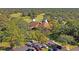 Beautiful aerial view of the clubhouse surrounded by lush, mature trees and ample parking at 13009 Wedgewood Way # 63-D, Hudson, FL 34667