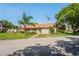 Exterior view of the building with mature trees, manicured landscaping and community pride at 13009 Wedgewood Way # 63-D, Hudson, FL 34667