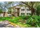 Charming condo with lush landscaping and a well-maintained lawn, inviting visitors into the property at 13009 Wedgewood Way # 63-D, Hudson, FL 34667