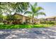 Charming exterior view of the building with well-maintained landscaping and a lush green lawn at 13009 Wedgewood Way # 63-D, Hudson, FL 34667