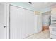 Kitchen area featuring a refrigerator, bi-fold door pantry, and white tile floors at 13009 Wedgewood Way # 63-D, Hudson, FL 34667
