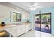 Functional kitchen with ample cabinet space, tiled floors, and a sliding glass door to the balcony at 13009 Wedgewood Way # 63-D, Hudson, FL 34667