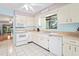 Bright kitchen with white appliances, tile floor, and ample cabinet space at 13009 Wedgewood Way # 63-D, Hudson, FL 34667