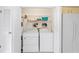Laundry room with washer, dryer, and wire shelving for storage at 13009 Wedgewood Way # 63-D, Hudson, FL 34667