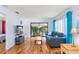 Bright living room boasts laminated floors, comfortable furniture, and a sliding glass door to the outdoor space at 13009 Wedgewood Way # 63-D, Hudson, FL 34667