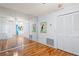 Bright living room with wood floors, mirror wall and adjacent closet storage at 13009 Wedgewood Way # 63-D, Hudson, FL 34667