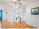 Inviting living room featuring wood floors, a ceiling fan, and a white front door at 13009 Wedgewood Way # 63-D, Hudson, FL 34667