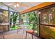 Sunroom featuring large windows, a ceiling fan, a small dining set, and carpeted floors providing a cozy space to relax at 13009 Wedgewood Way # 63-D, Hudson, FL 34667
