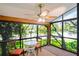 Bright sunroom featuring large windows with a ceiling fan and a small dining set, offering a relaxing space with natural light at 13009 Wedgewood Way # 63-D, Hudson, FL 34667
