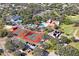 Wonderful aerial view of the red tennis courts, golf course, clubhouse, and pool at 13009 Wedgewood Way # 63-D, Hudson, FL 34667