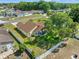 Aerial view of a single-Gathering home with lush landscaping and a long driveway at 13491 Coronado Dr, Spring Hill, FL 34609