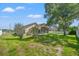 Home featuring a lush backyard with a screened-in patio, perfect for outdoor relaxation at 13491 Coronado Dr, Spring Hill, FL 34609