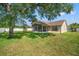Home featuring a lush backyard with a screened-in patio, perfect for outdoor relaxation at 13491 Coronado Dr, Spring Hill, FL 34609