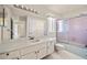 Bathroom featuring large vanity, toilet, and shower-tub combo at 13491 Coronado Dr, Spring Hill, FL 34609