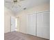 Bright bedroom features a ceiling fan and spacious closet, offering ample storage space at 13491 Coronado Dr, Spring Hill, FL 34609