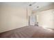Large carpeted bedroom with an adjacent bathroom and closet for convenience at 13491 Coronado Dr, Spring Hill, FL 34609