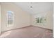Spacious bedroom with plush carpeting, high ceilings, neutral paint, and a ceiling fan at 13491 Coronado Dr, Spring Hill, FL 34609