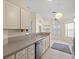 Bright kitchen with stainless steel appliances and white cabinets that lead to a sunny breakfast nook at 13491 Coronado Dr, Spring Hill, FL 34609