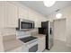 Kitchen featuring white cabinets, a breakfast bar, and stainless steel appliances at 13491 Coronado Dr, Spring Hill, FL 34609
