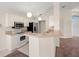 Bright kitchen with white cabinetry, stainless appliances, and an open layout at 13491 Coronado Dr, Spring Hill, FL 34609