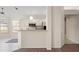 Open kitchen featuring white cabinets, stainless steel appliances, and a breakfast bar at 13491 Coronado Dr, Spring Hill, FL 34609
