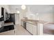 Kitchen featuring modern appliances, white cabinetry, and a breakfast bar overlooking the living area at 13491 Coronado Dr, Spring Hill, FL 34609